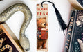 a bookmark with a picture of a bear and a snake