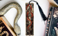 a snake, a bookmark, and two books on a table