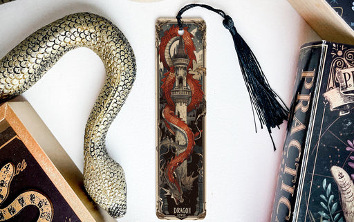 a snake, a bookmark, and two books on a table