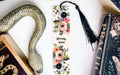 a bookmark with a snake and flowers on it
