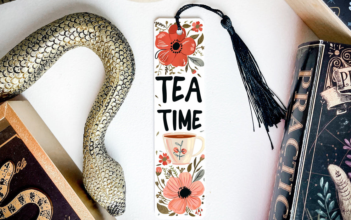 a bookmark that says tea time next to a snake