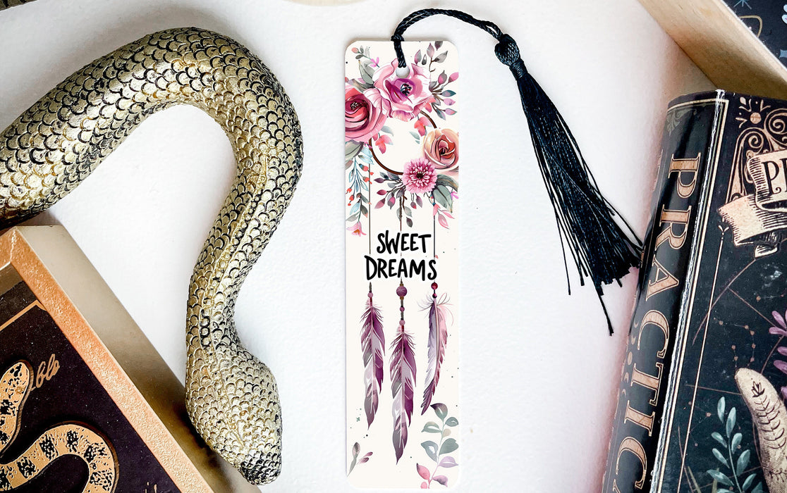 a bookmark with flowers and feathers on it