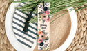 a close up of a plate with a flower bookmark