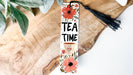 a bookmark that says tea time with flowers on it