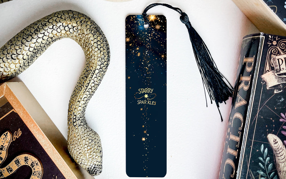 a bookmark with a snake on it next to other books