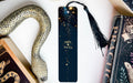 a bookmark with a snake on it next to other books