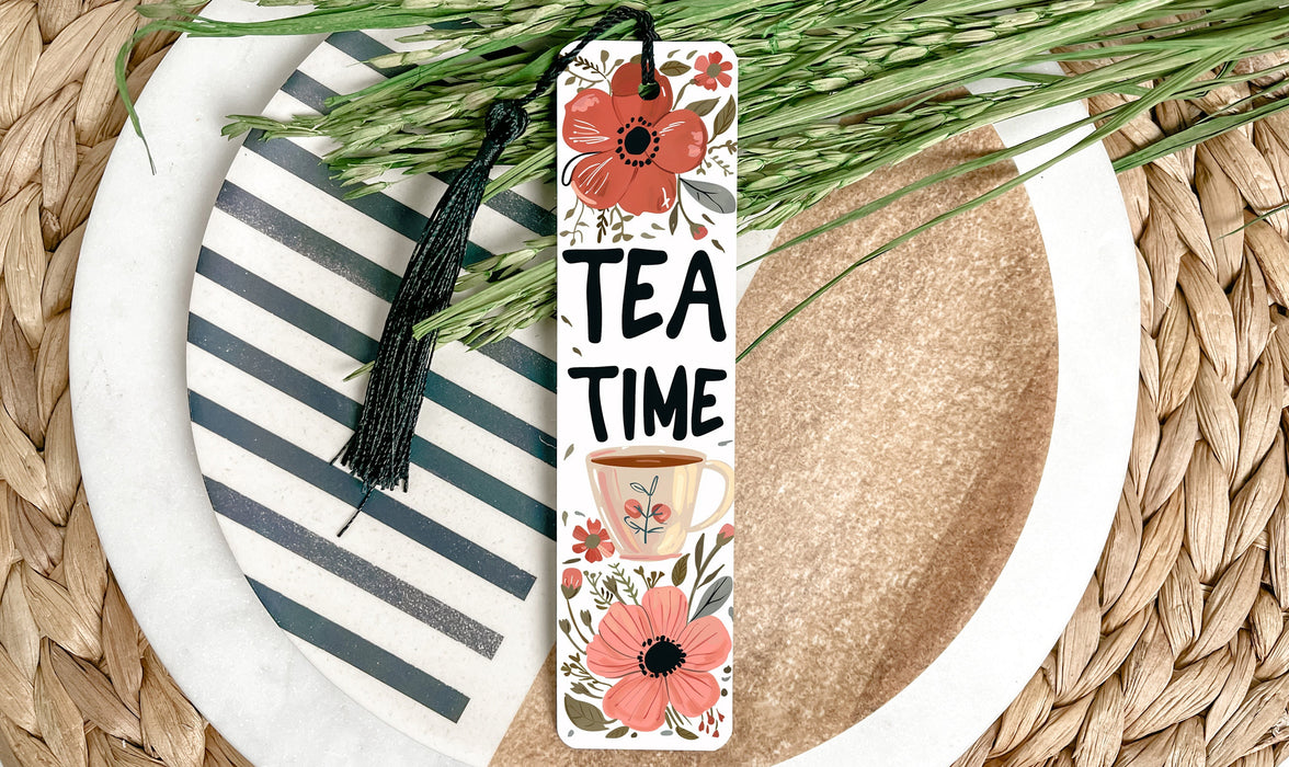 a white plate topped with a cup of tea and a bookmark
