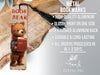 a bookmark with a picture of a bear holding a book