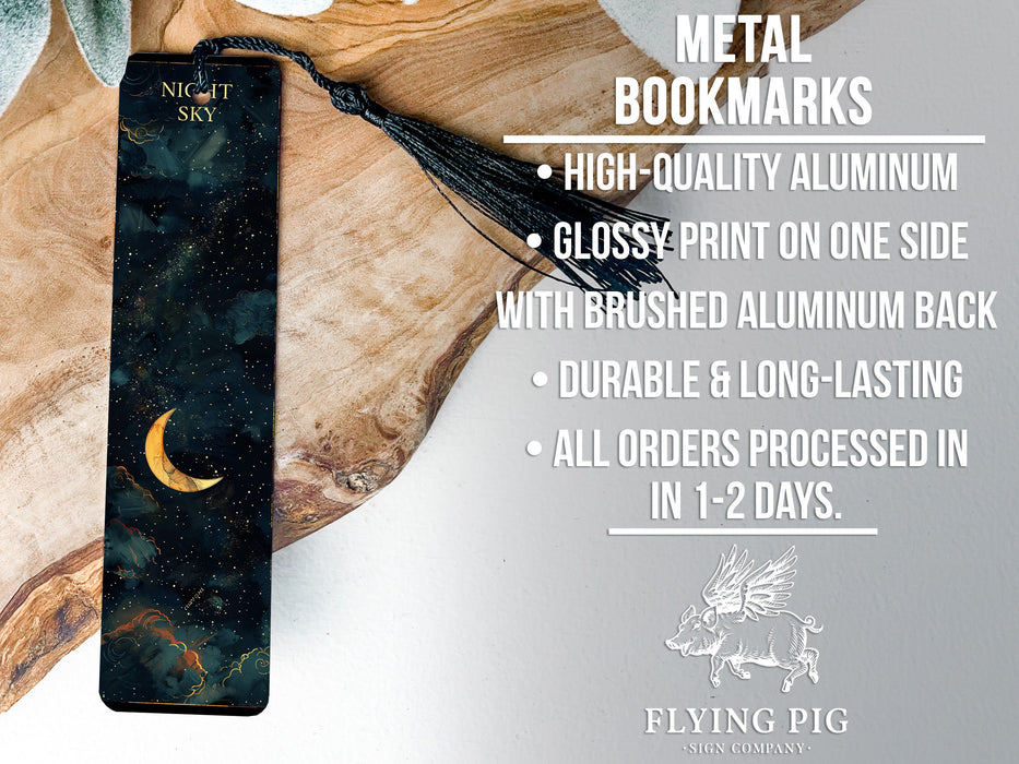 a metal bookmark with a crescent moon on it
