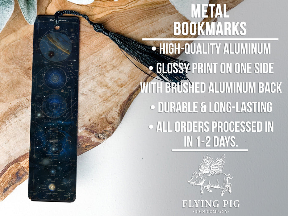 a metal clock sitting on top of a piece of wood