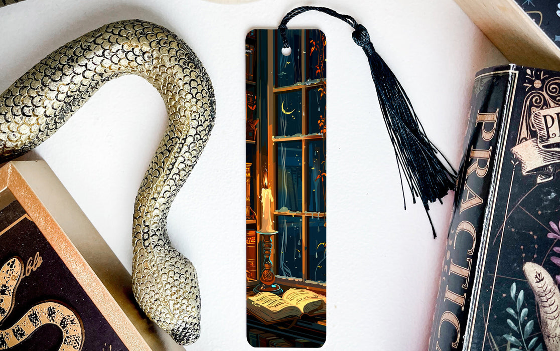 a bookmark with a snake on it next to a book