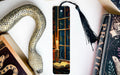 a bookmark with a snake on it next to a book