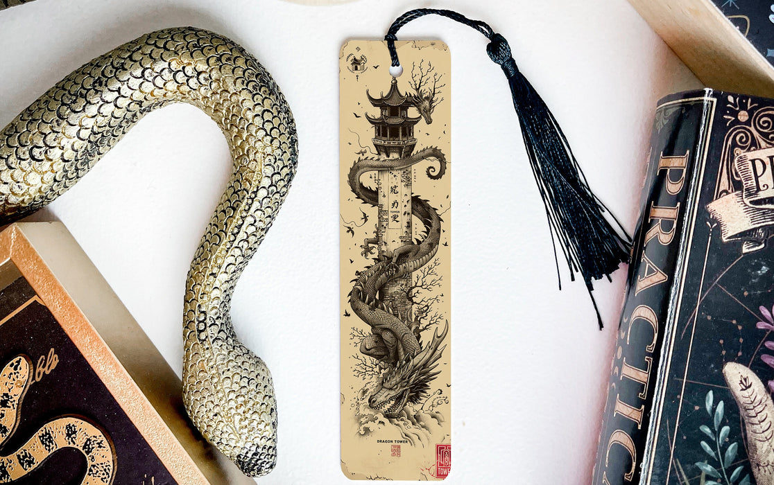 a bookmark with a snake on it next to books