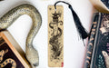 a bookmark with a snake on it next to books