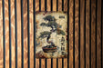 a painting of a bonsai tree on a wooden wall