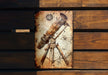 an old metal sign with a telescope on it