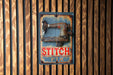 an old sewing machine hanging on a wooden wall