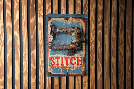 an old sewing machine hanging on a wooden wall