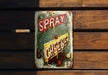 a sign on a wooden bench that says spray cheese