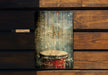 a wooden wall with a drum painted on it