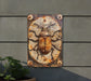 a rusted metal sign with a bug on it
