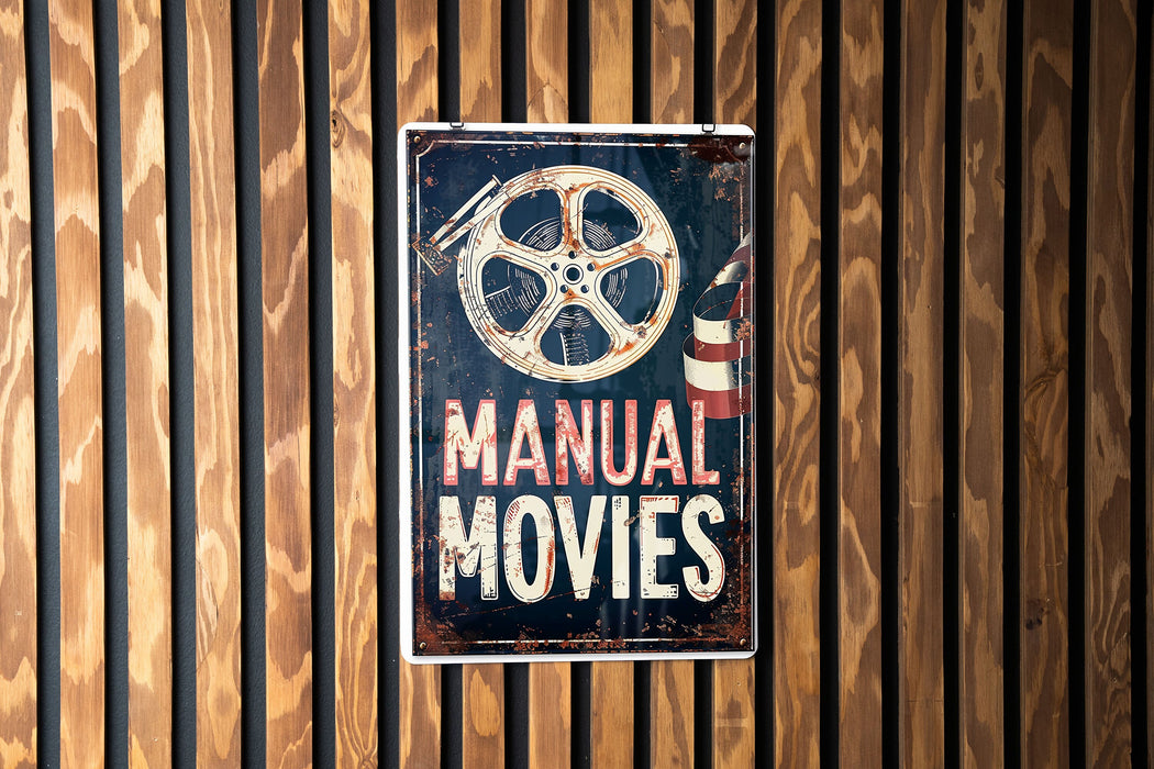 a sign on a wooden wall that says manual movies