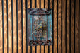 a picture of a bird in a cage on a wall