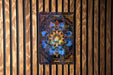 a picture of a flower on a wooden wall