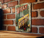 a sign on a brick wall that says spray cheese