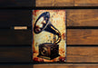 a metal sign with a picture of a speaker on it