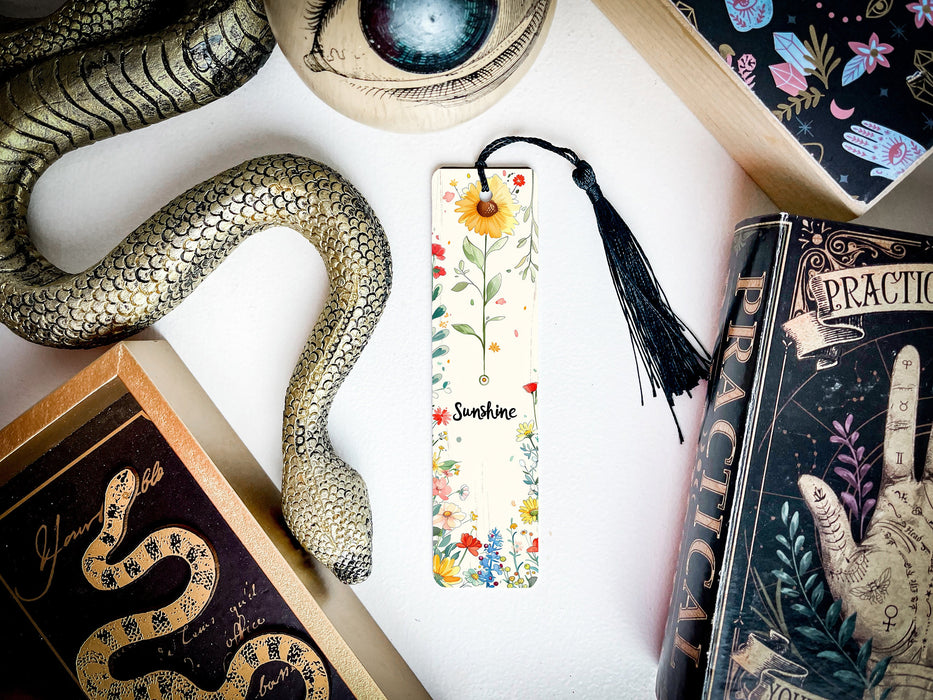 a bookmark with a snake on it next to other books