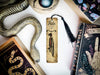 a snake, a bookmark, and other items on a table