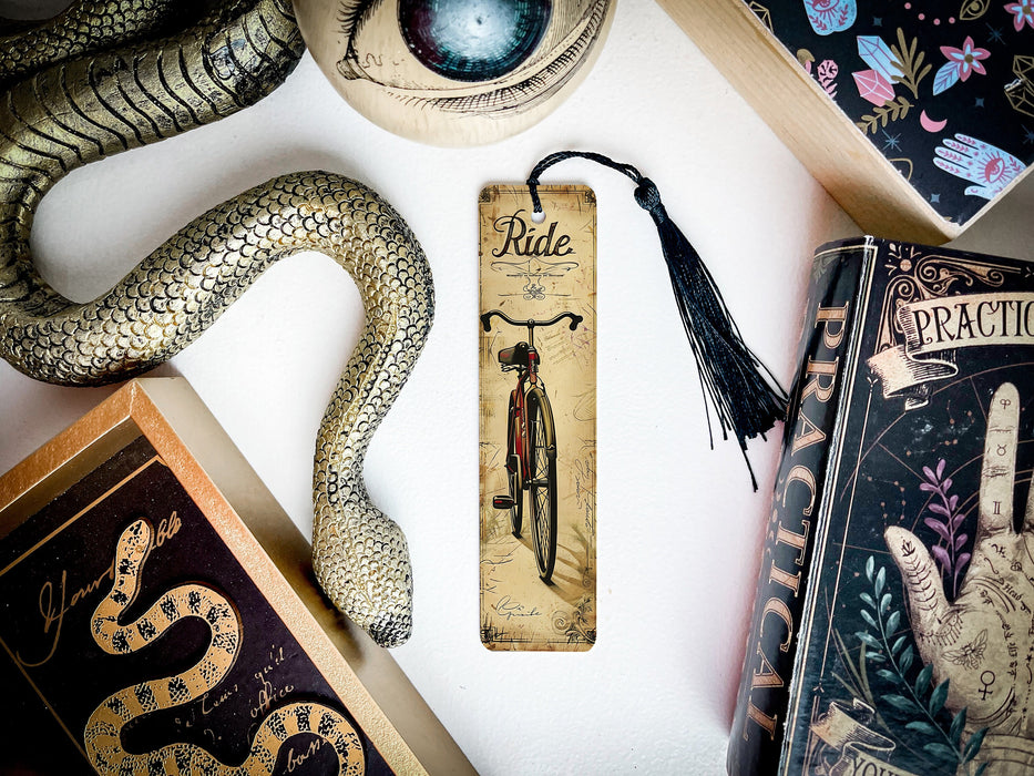 a snake, a bookmark, and other items on a table