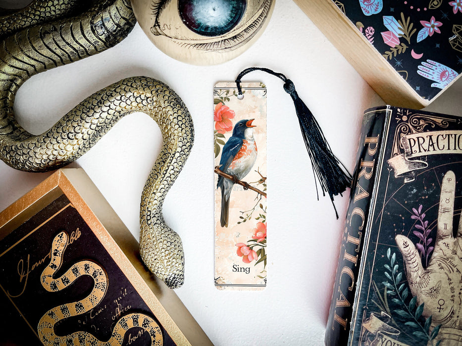 a bookmark with a bird on it next to a snake