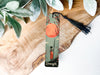 a bookmark with a picture of a tree and a sunset