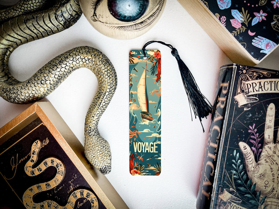 a bookmark with a snake on it next to other books