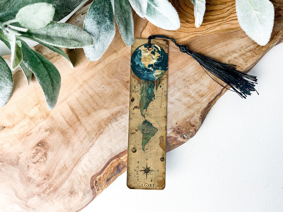 a wooden ruler with a tassel on top of it