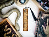 a snake, a bookmark, and other items on a table