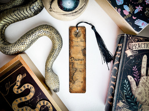 a snake, a bookmark, and other items on a table