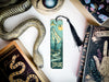 a bookmark with a snake on it next to other books