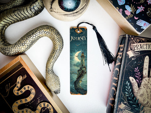 a bookmark with a snake on it next to other books