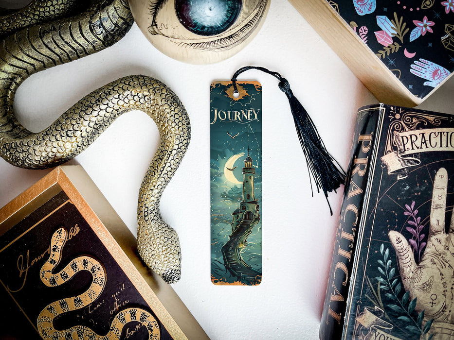 a bookmark with a snake on it next to other books