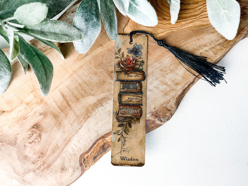 a wooden bookmark with a tassel hanging from it