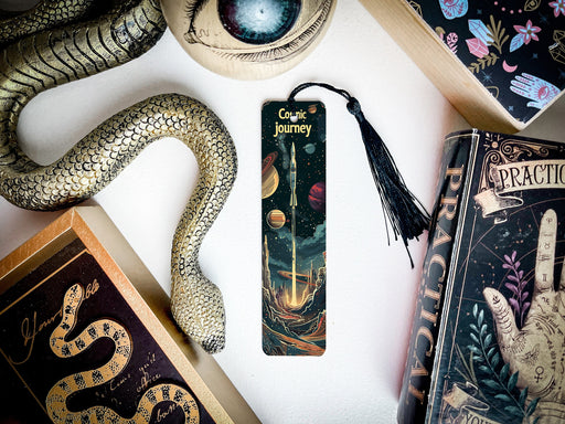 a bookmark with a snake on it next to other books