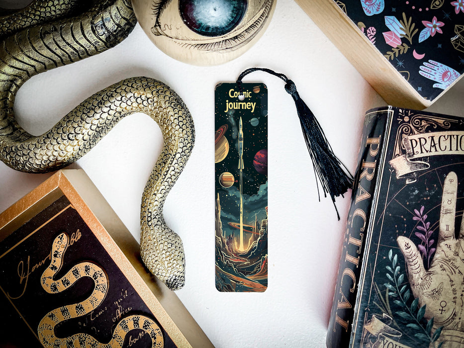 a bookmark with a snake on it next to other books