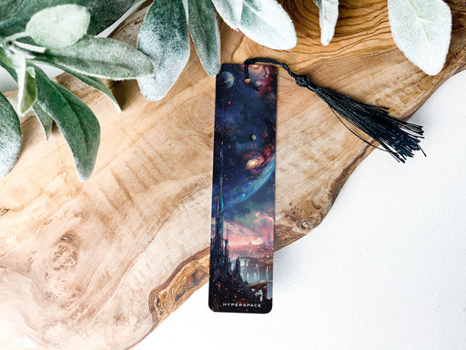 a bookmark sitting on top of a wooden table next to a plant