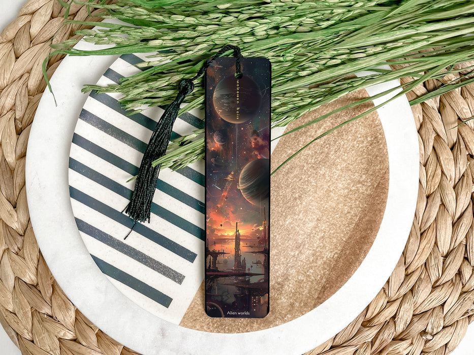 a bookmark sitting on top of a table next to a plant