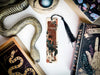 a snake, bookmark, and other items on a table