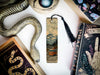 a bookmark with a snake on it next to other books