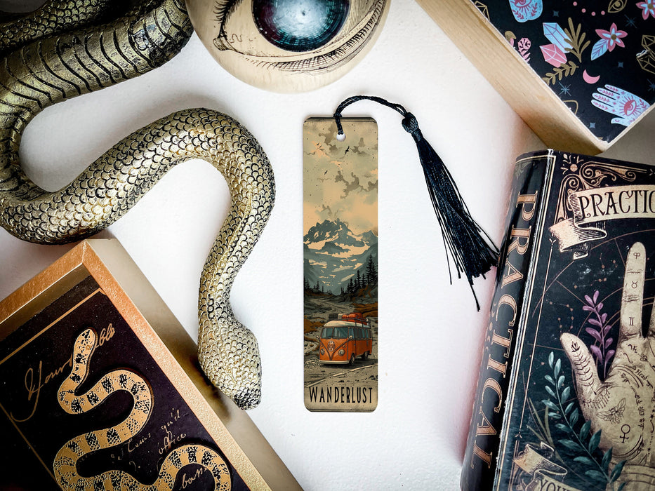 a bookmark with a snake on it next to other books